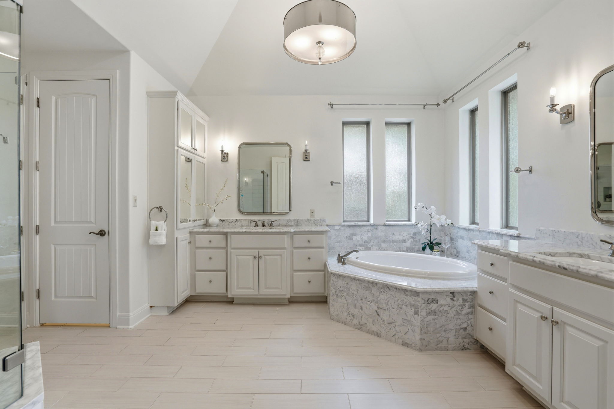 2420 Legend Trail Leander, TX 78641 - Photo 18 of 40 Spacious and sun-drenched, this primary ensuite has a deep soaking tub perfectly positioned between dual vanities. It’s the ultimate spot to decompress after a long day.