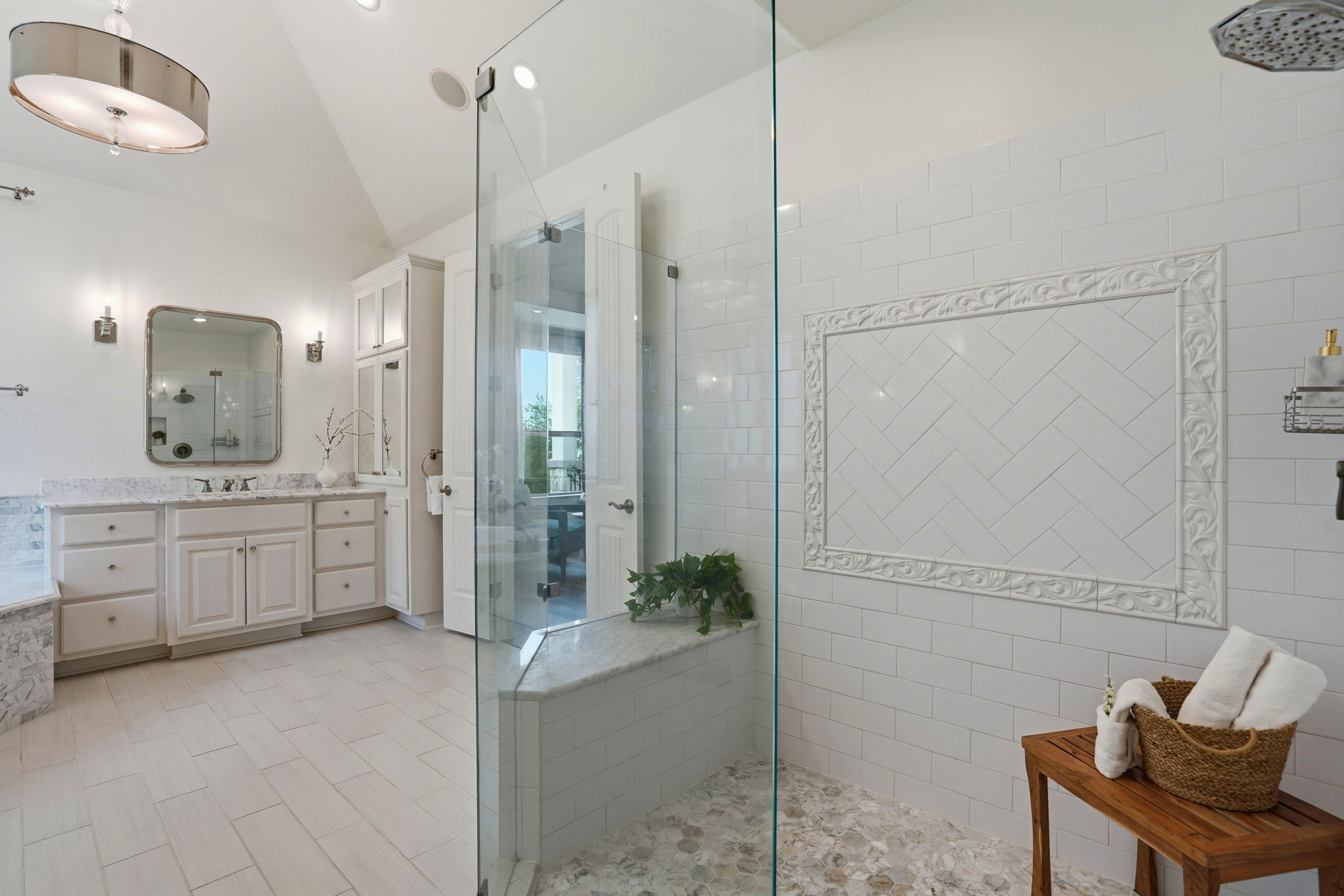 2420 Legend Trail Leander, TX 78641 - Photo 20 of 40 Step into the oversized walk-in shower, where intricate herringbone tilework creates a sophisticated focal point.