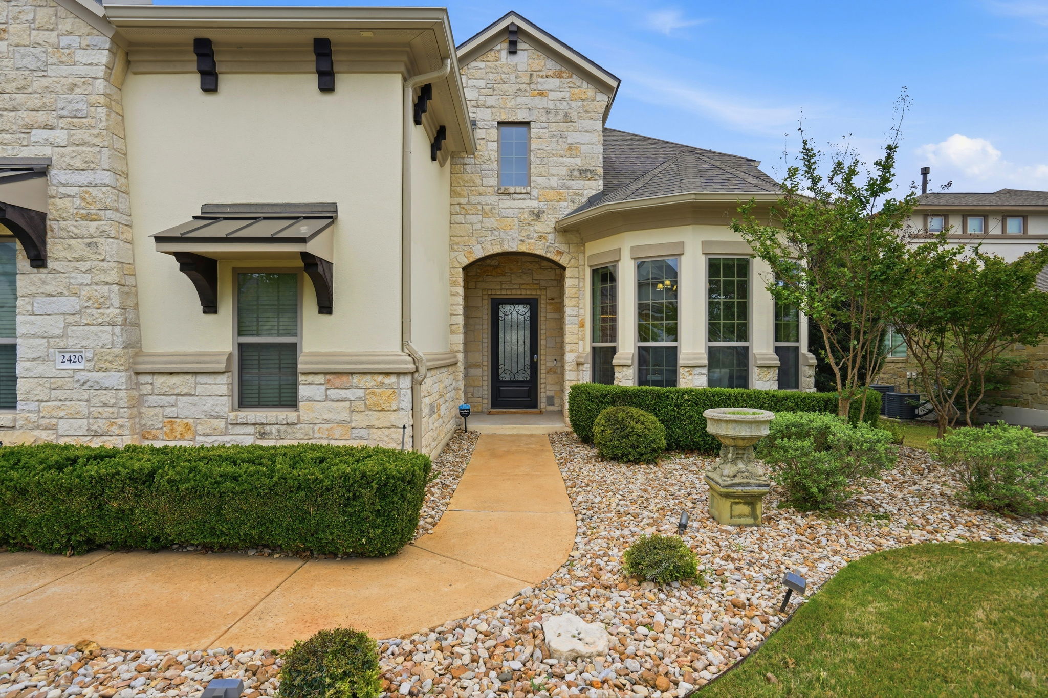 2420 Legend Trail Leander, TX 78641 - Photo 2 of 40 The arched stone entryway and manicured landscaping invite you in to see all this 5 bedroom and 4 and a half bath home has to offer.