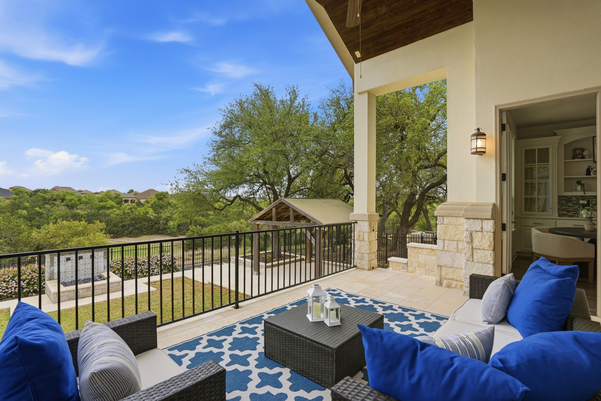 2420 Legend Trail Leander, TX 78641 - Photo 35 of 40 Sip your morning coffee with a view. This elevated patio features a striking wood ceiling and overlooks a meticulously designed backyard and the lush greenbelt beyond.