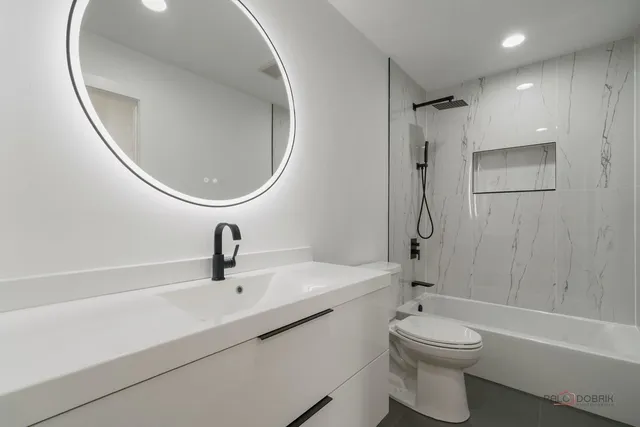 a bathroom with a sink a toilet and a mirror