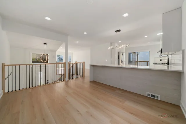 a view of a kitchen with a sink and wooden floor