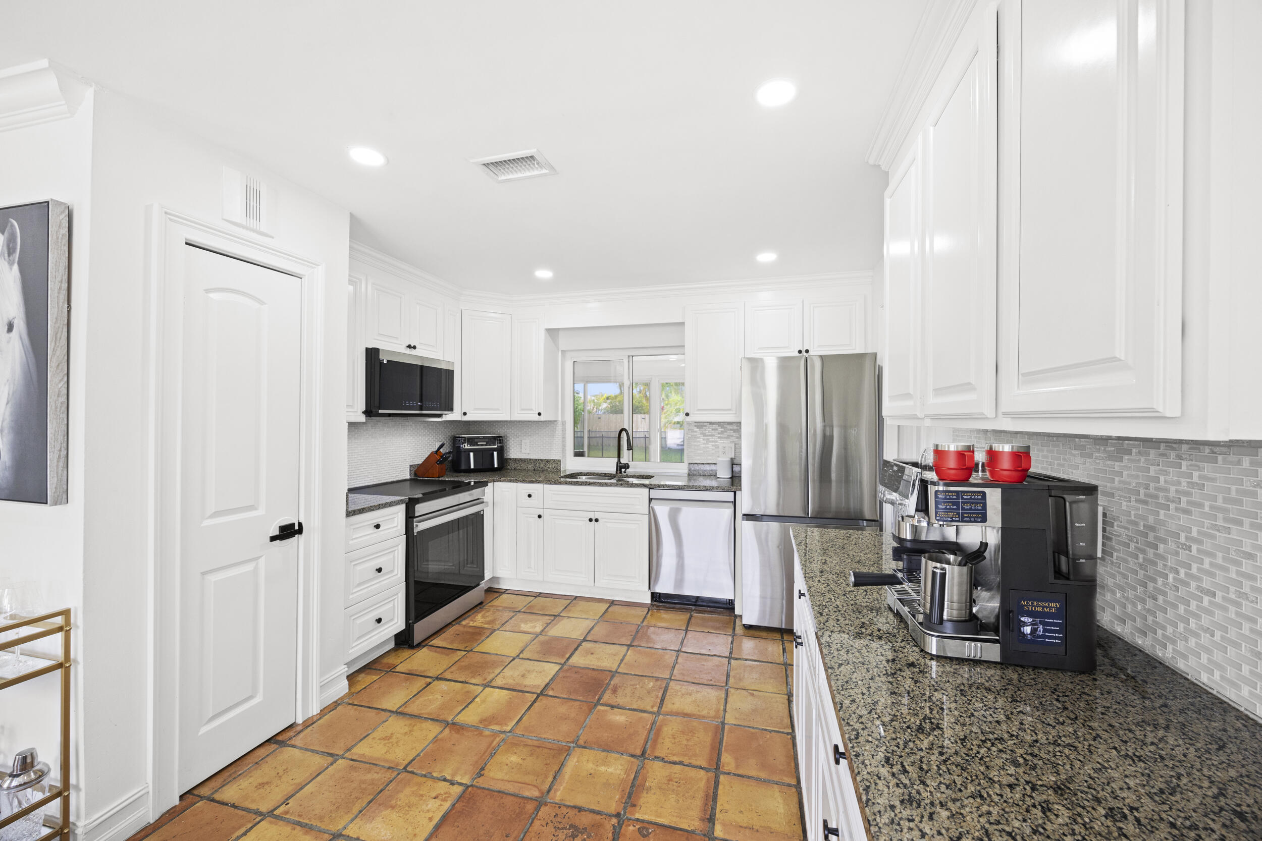 11760 Inverness Circle Wellington, FL 33414 - Photo 12 of 33 a kitchen with sink cabinets and stainless steel appliances