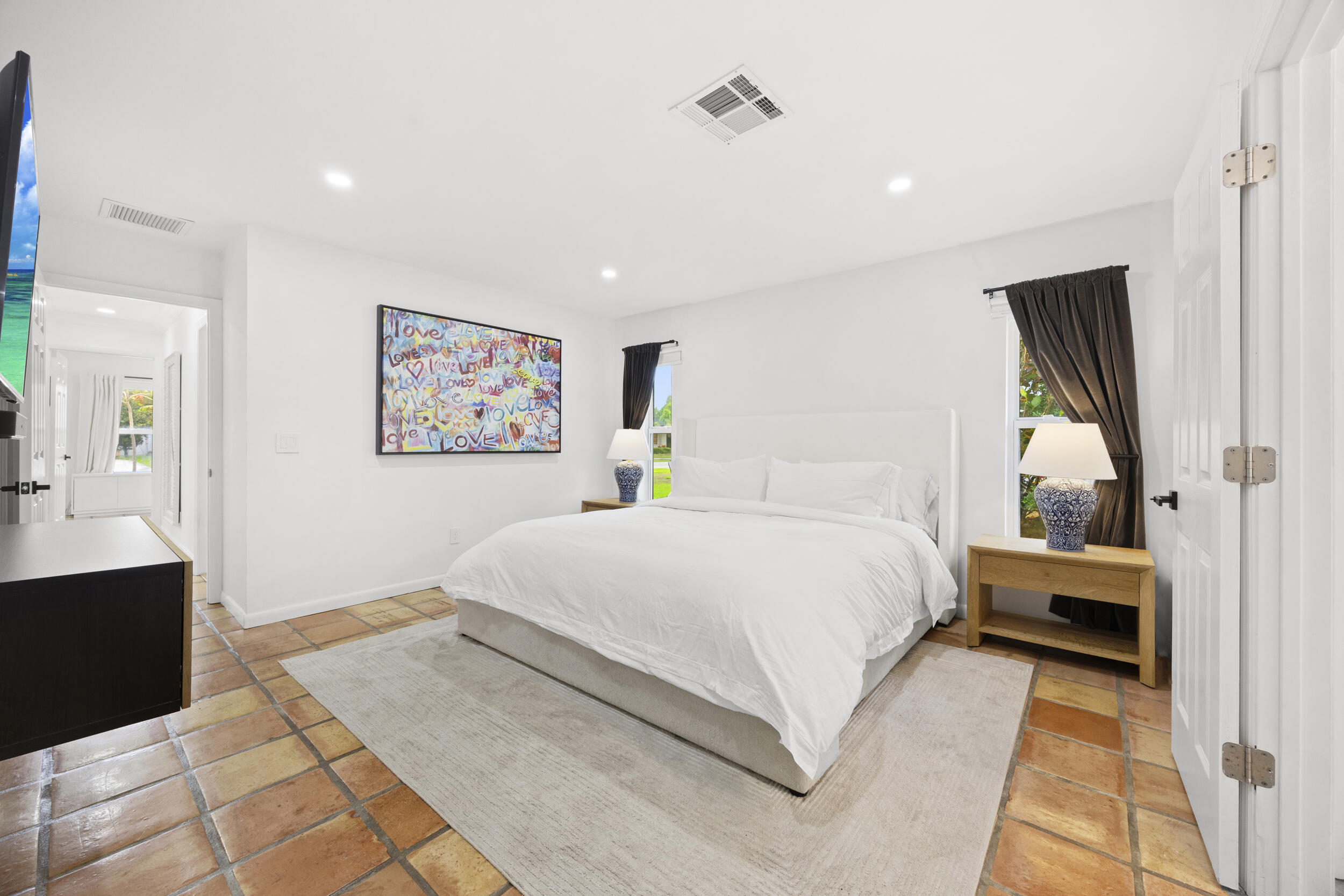 11760 Inverness Circle Wellington, FL 33414 - Photo 15 of 33 a spacious bedroom with a large bed and a chandelier