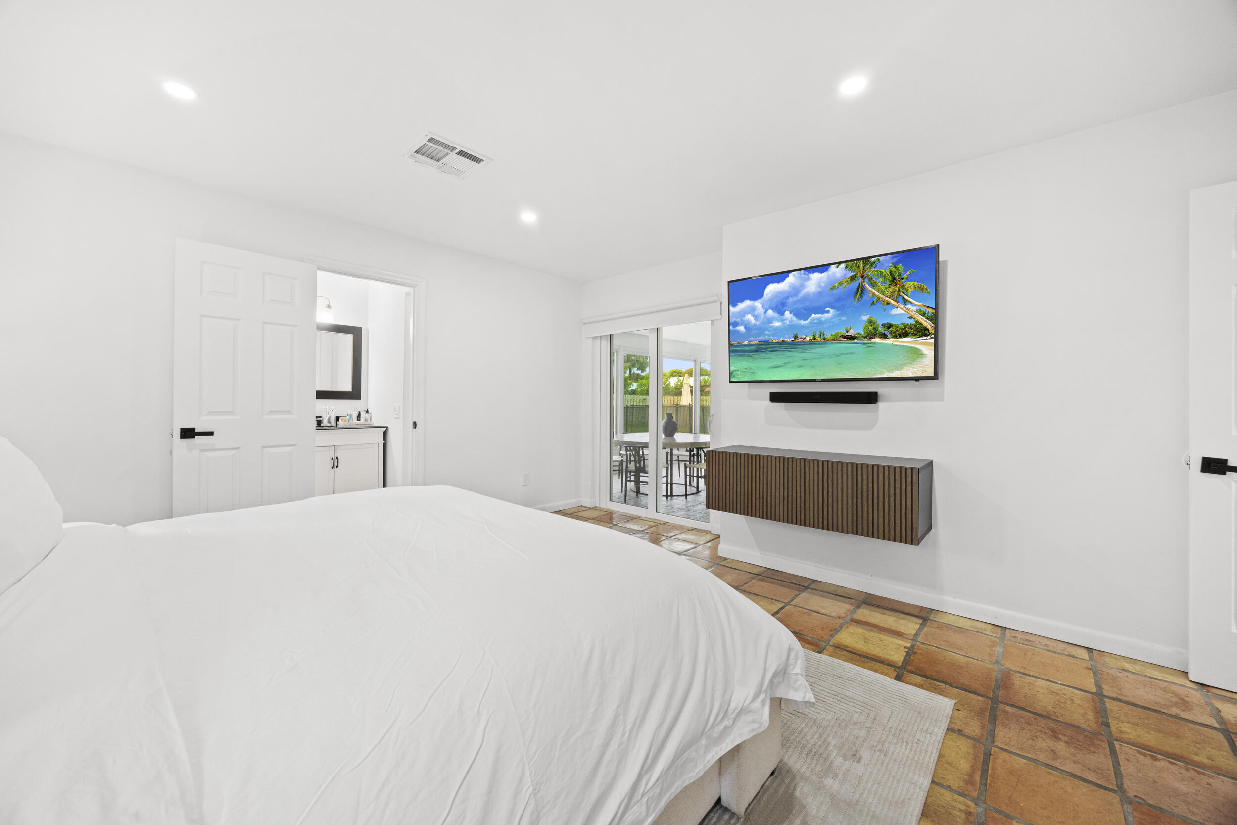 11760 Inverness Circle Wellington, FL 33414 - Photo 16 of 33 a bedroom with a bed and a flat screen tv