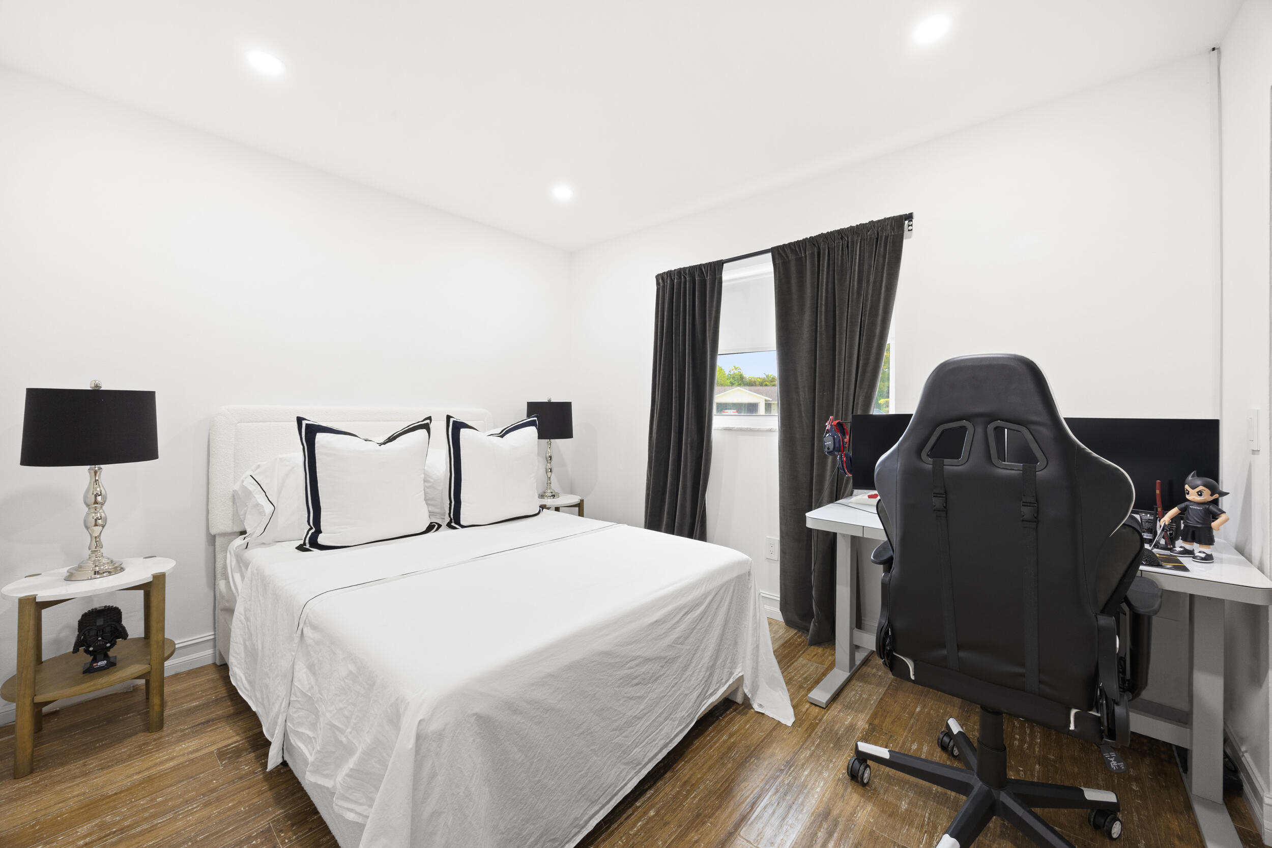 11760 Inverness Circle Wellington, FL 33414 - Photo 20 of 33 a bedroom with a bed and wooden floor