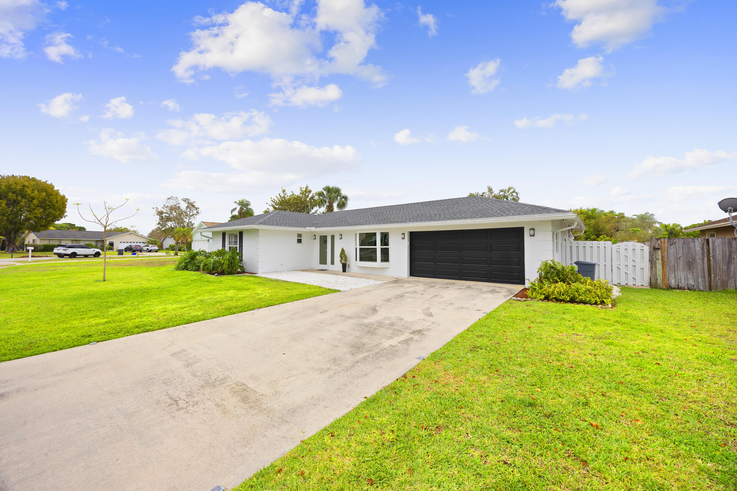 11760 Inverness Circle Wellington, FL 33414 - Photo 2 of 33 a front view of house with yard and green space