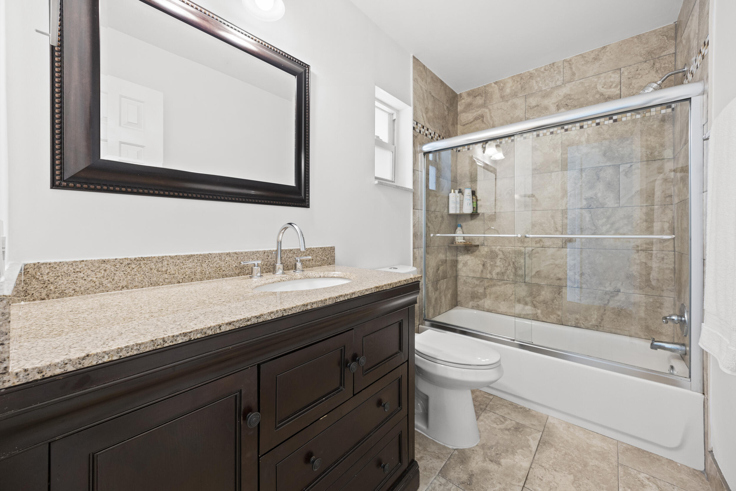 11760 Inverness Circle Wellington, FL 33414 - Photo 24 of 33 a bathroom with a granite countertop sink a toilet and bathtub