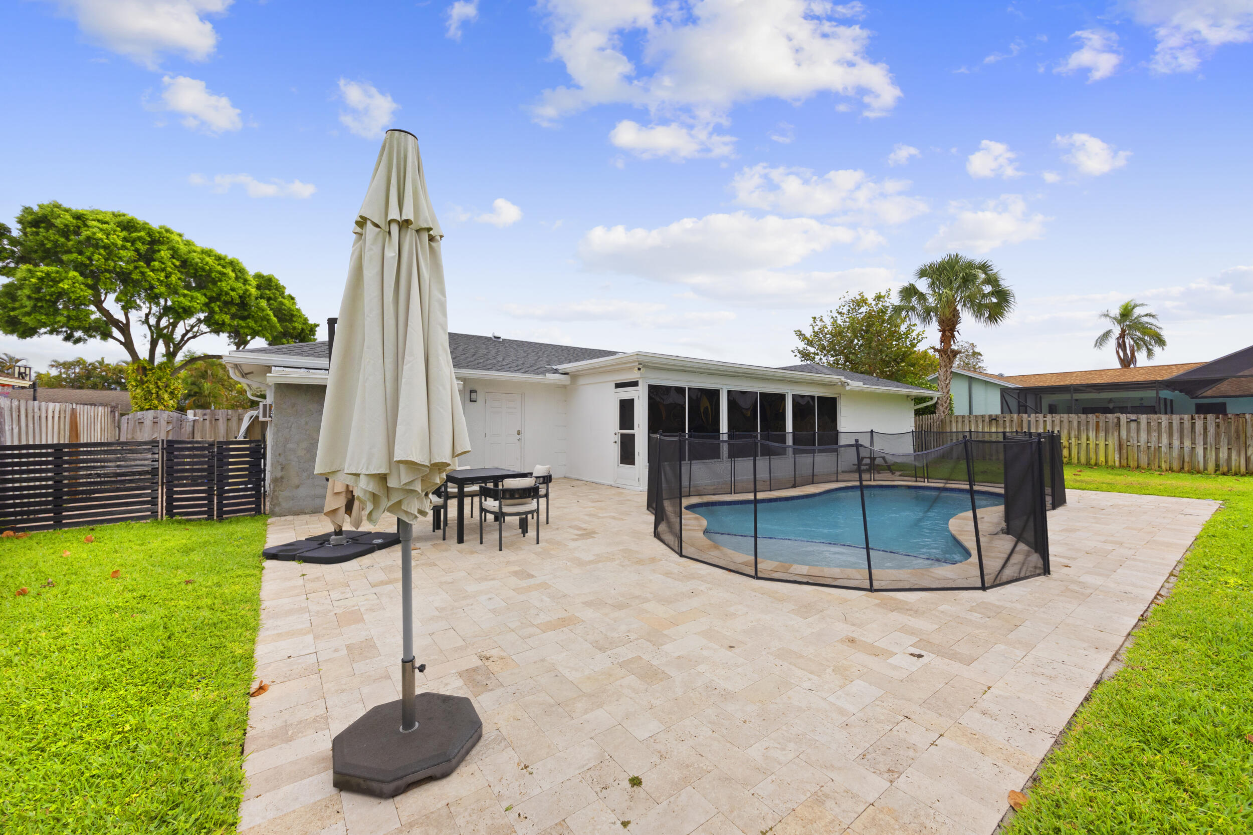 11760 Inverness Circle Wellington, FL 33414 - Photo 28 of 33 a view of a backyard with swimming pool