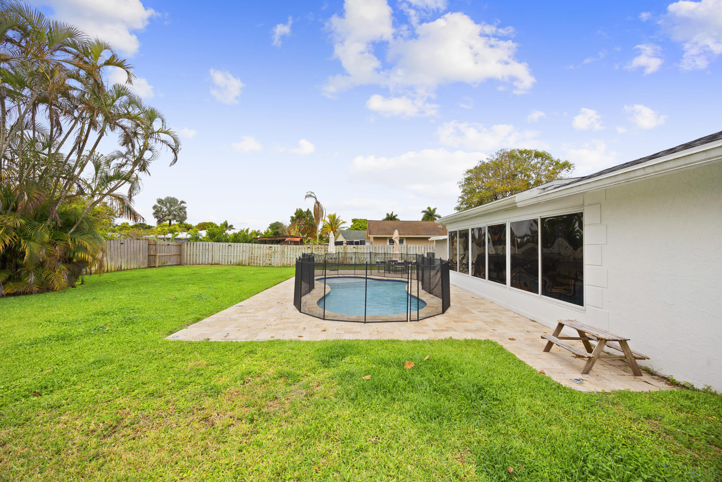 11760 Inverness Circle Wellington, FL 33414 - Photo 31 of 33 a house view with swimming pool and garden space