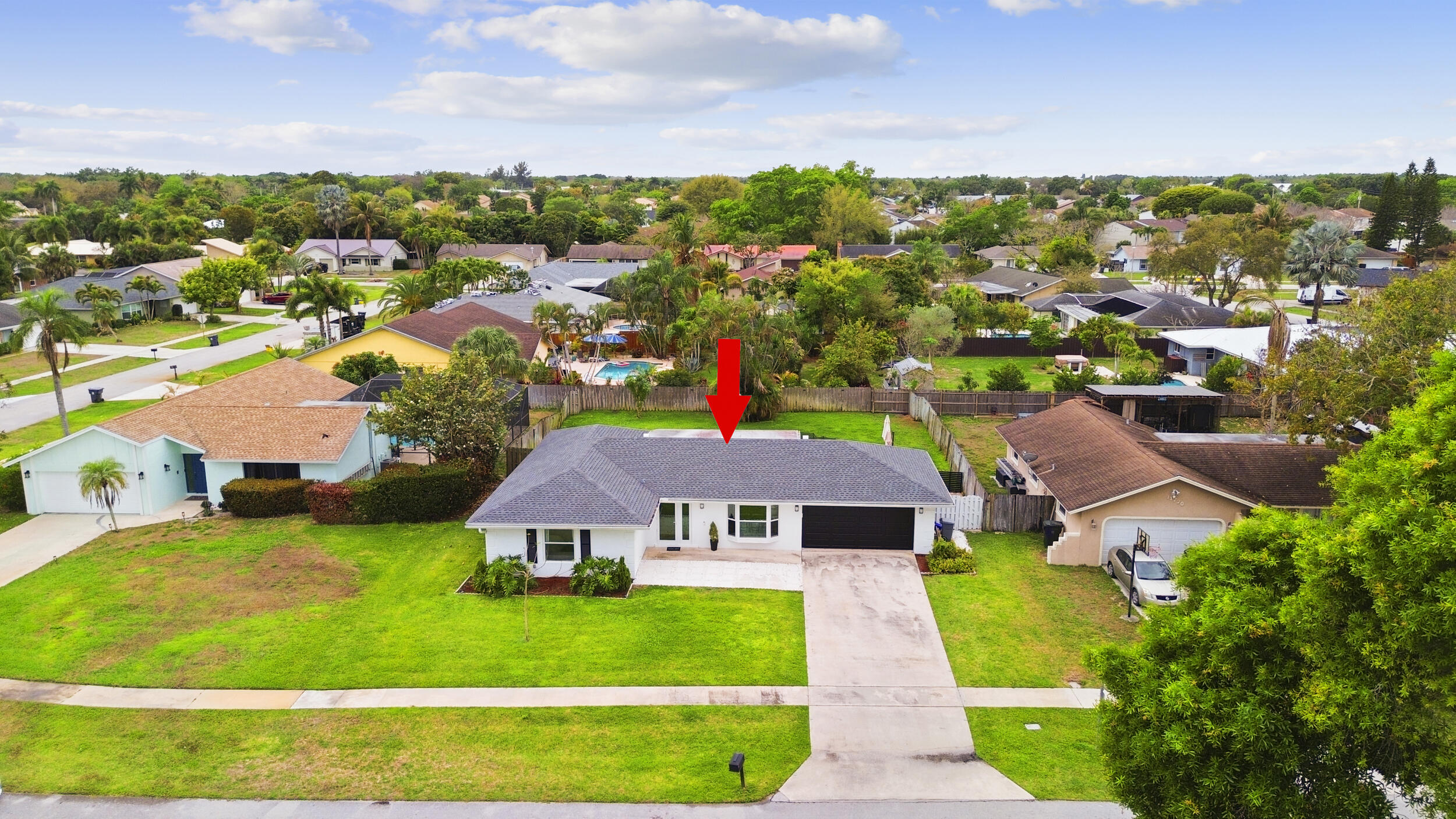 11760 Inverness Circle Wellington, FL 33414 - Photo 32 of 33 a aerial view of a house with a big yard plants and large trees