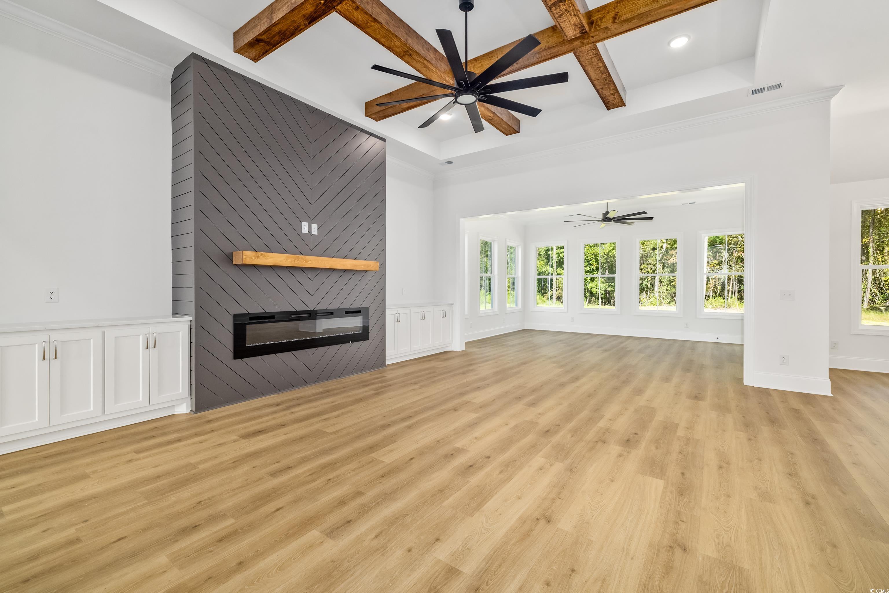 346 Ridge Road Galivants Ferry, SC 29544 - Photo 16 of 24 Unfurnished living room featuring a fireplace, light wood finished floors, beamed ceiling, coffered ceiling, and a ceiling fan