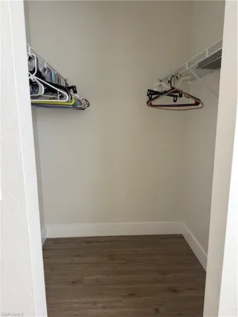 a view of a room with wooden floor and white walls