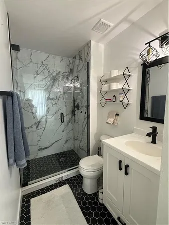 a bathroom with a sink toilet and shower