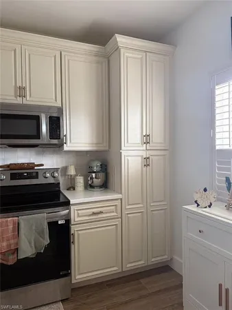 a kitchen with a stove and white cabinets