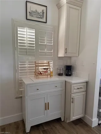 a kitchen with cabinets and window