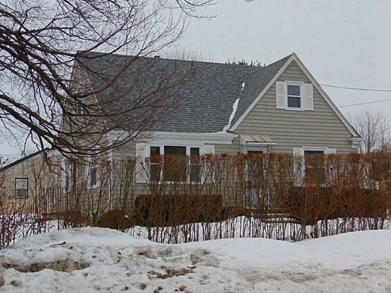 Exterior Front. Good looking house surrounded by hedge and wood fenced back yard.