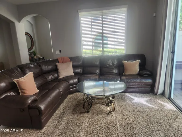 a living room with furniture and a window