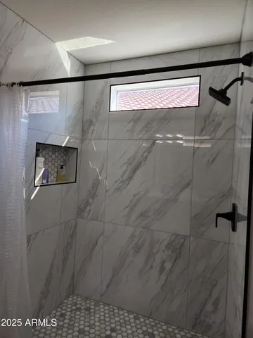 a bathroom with a shower and a shower