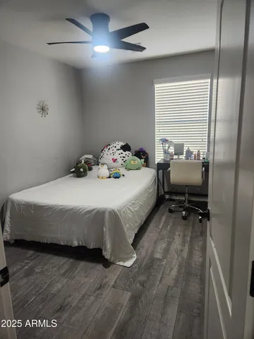 a bedroom with a bed and a mirror