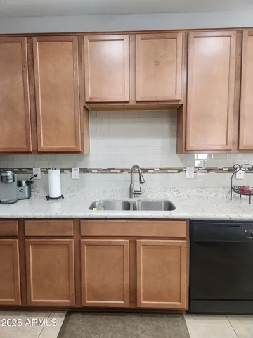 a kitchen with stainless steel appliances granite countertop a sink and a cabinets