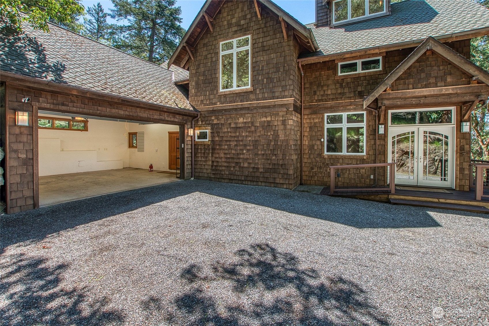 2270 Spring Point Road Orcas Island, WA 98245 - Photo 30 of 40 a front view of a house with a yard and garage