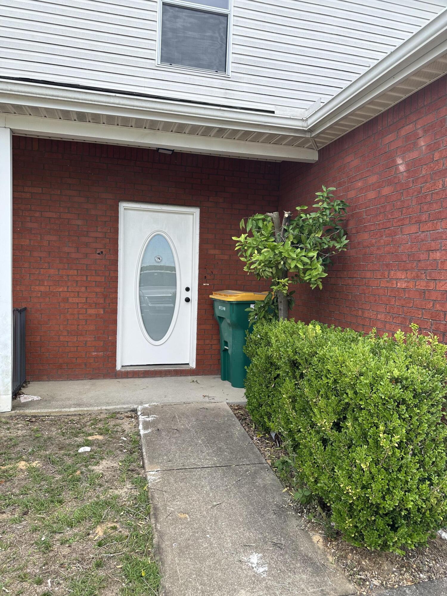 1150 Airport Road, Unit 138 Destin, FL 32541 - Photo 1 of 16 a front view of a house with a yard