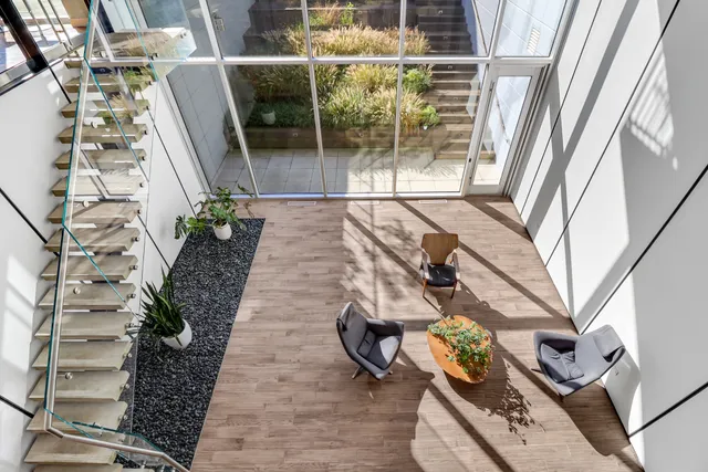 a vase of flowers sitting on a table in front of a window