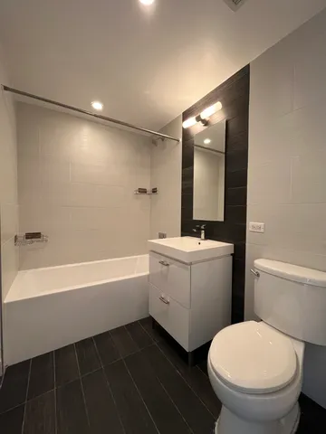 a bathroom with a toilet a sink and bathtub