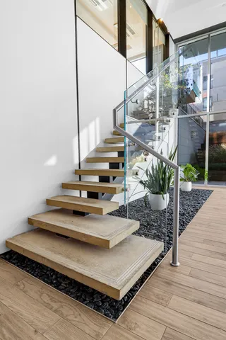a view of entryway and hall with wooden floor