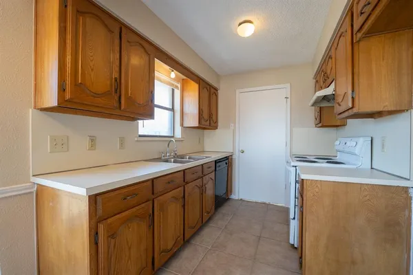 a kitchen with a sink stove and microwave