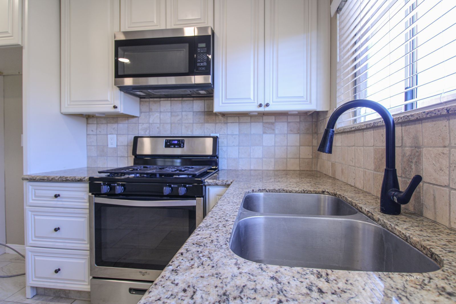 1532 South McCall Street Ridgecrest, CA 93555 - Photo 11 of 27 a kitchen with stainless steel appliances granite countertop a sink and a stove top oven