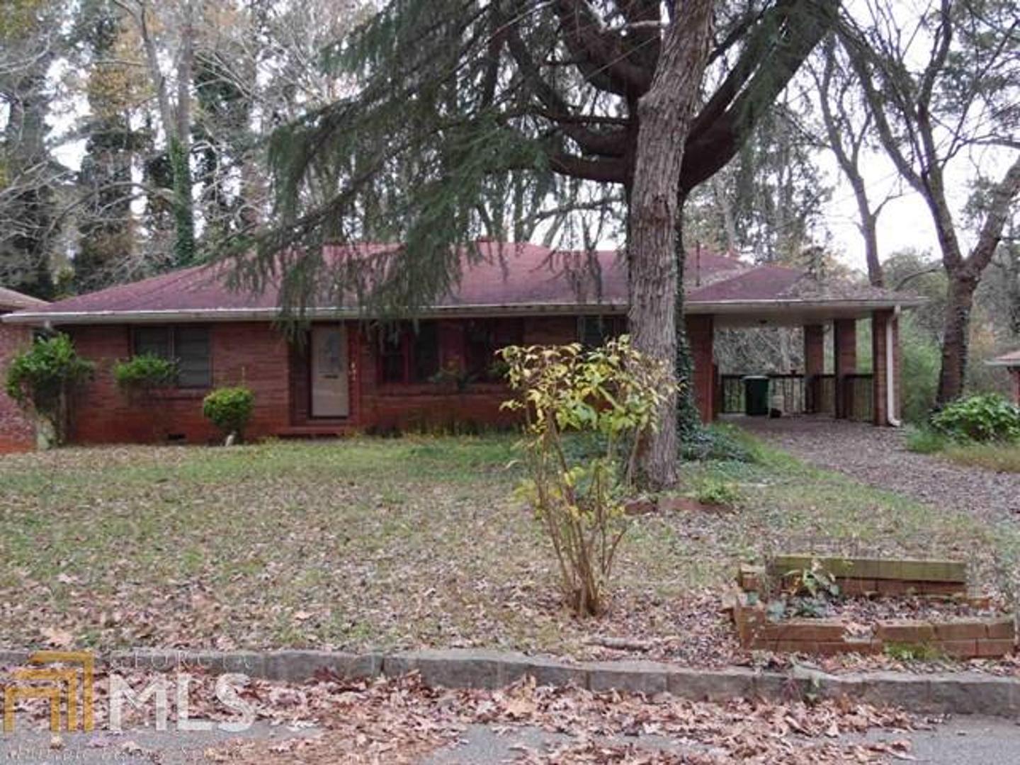 1885 Long Drive, Unit 5 Decatur, GA 30032 - Photo 1 of 1 a front view of a house with a tree in a yard