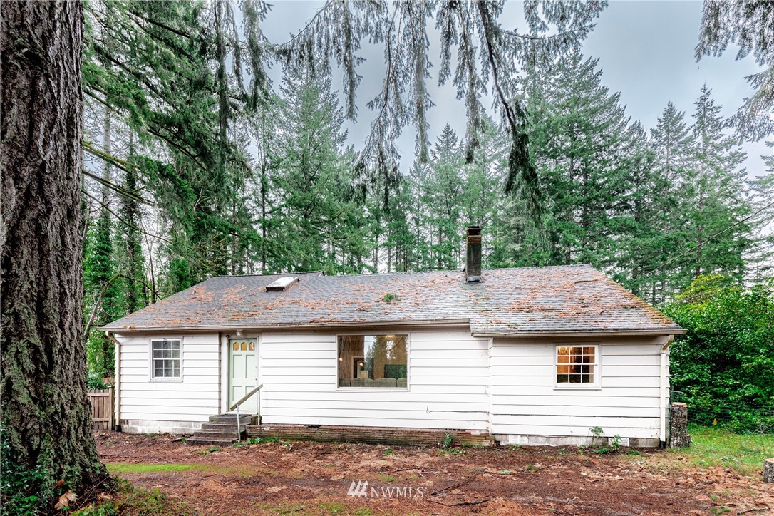 4004 Cooper Point Road Northwest Olympia, WA 98502 - Photo 1 of 28 a front view of a house with a yard