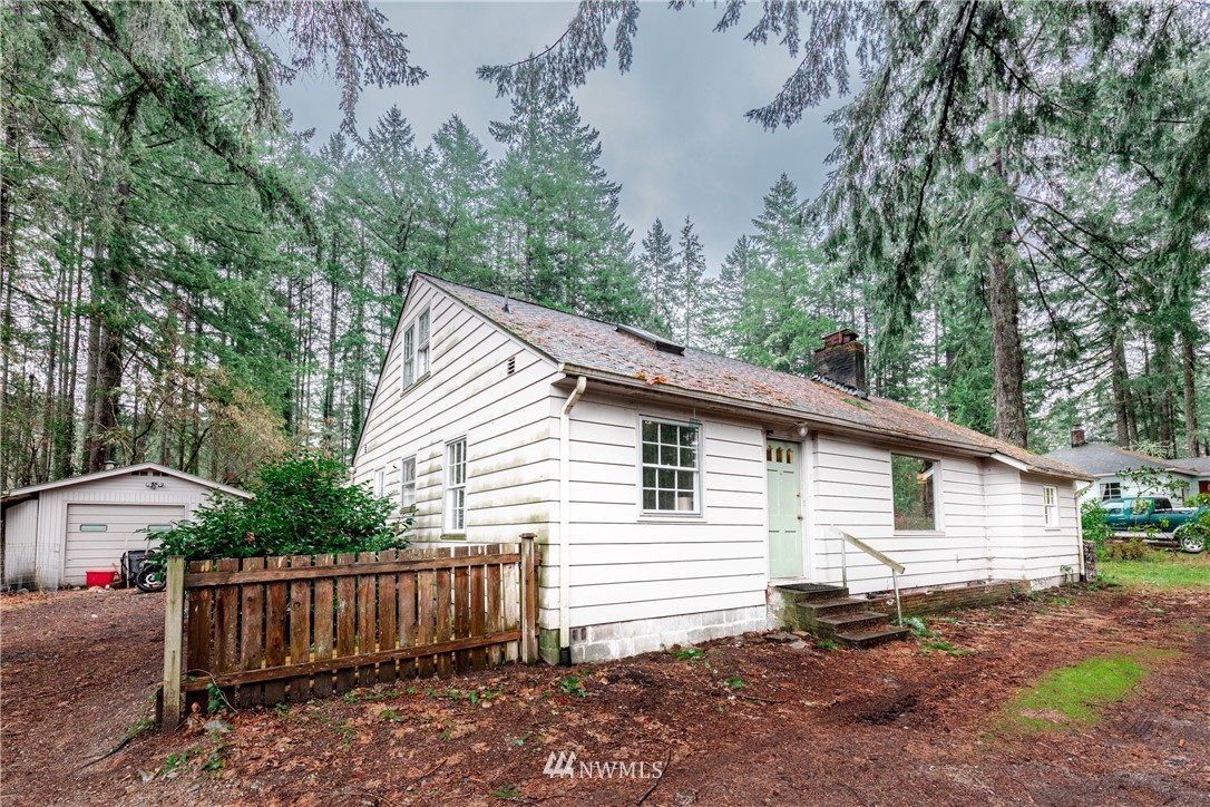 4004 Cooper Point Road Northwest Olympia, WA 98502 - Photo 2 of 28 a view of a house with a yard
