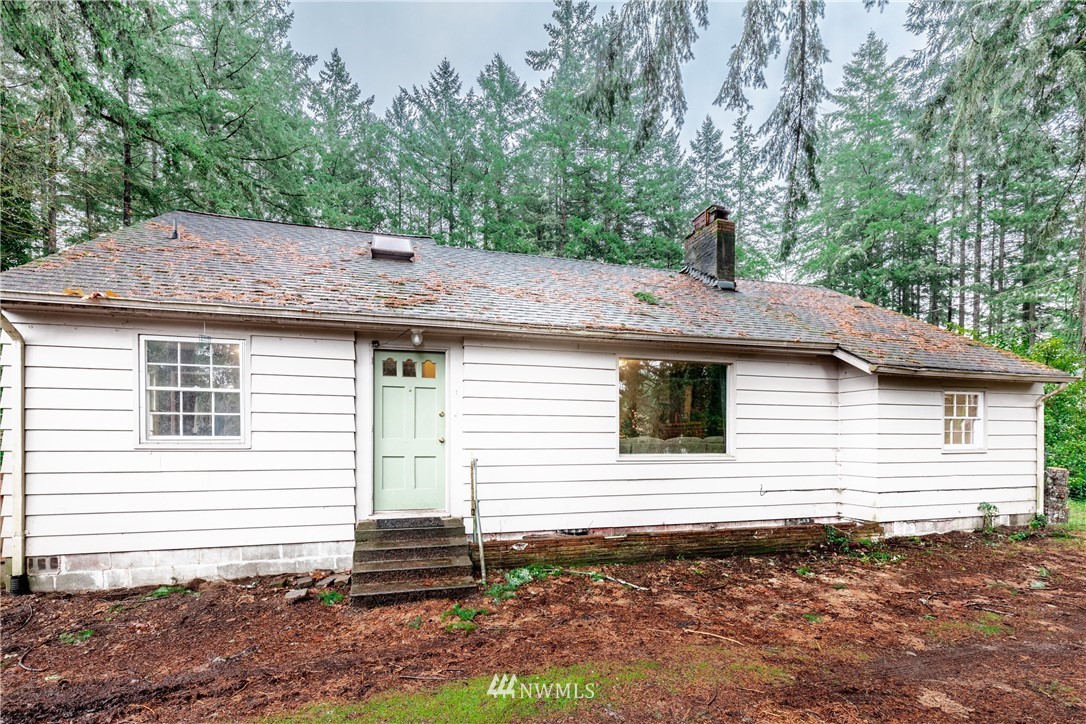 4004 Cooper Point Road Northwest Olympia, WA 98502 - Photo 3 of 28 a view of a house with a yard