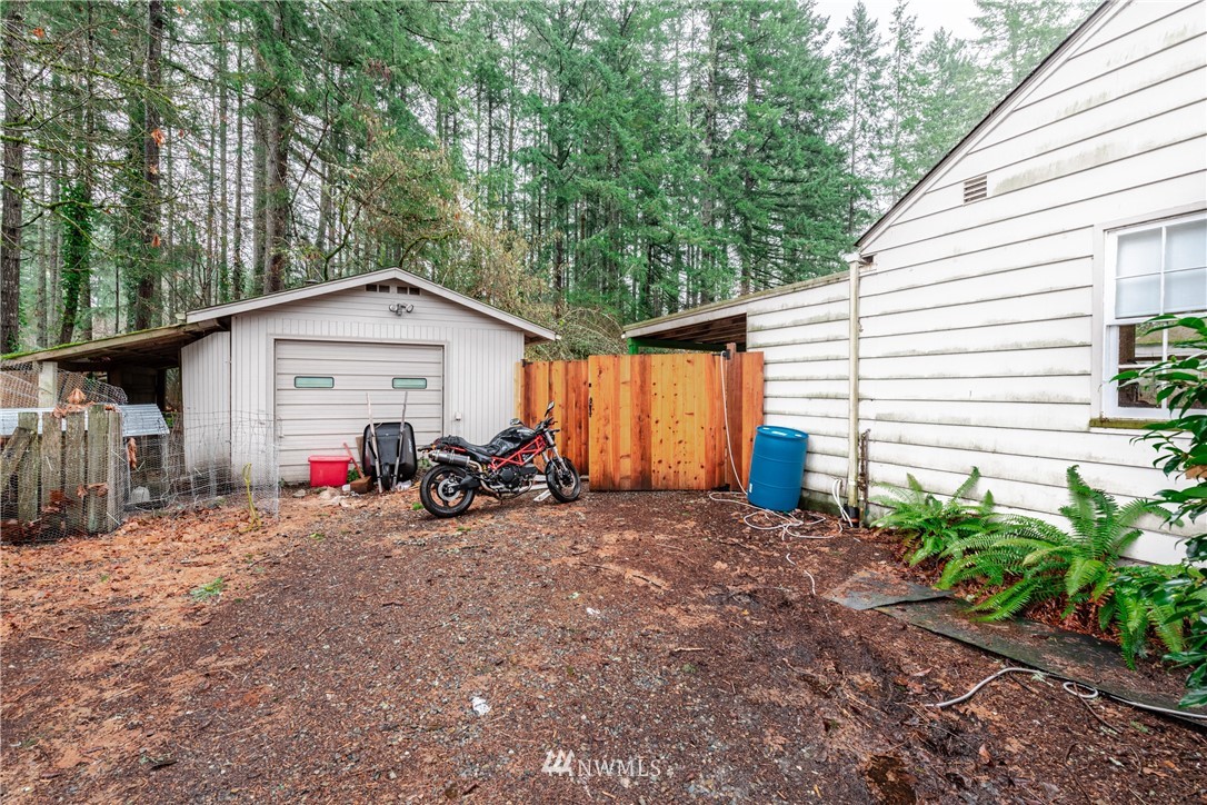 4004 Cooper Point Road Northwest Olympia, WA 98502 - Photo 24 of 28 a view of a house with a patio and a yard