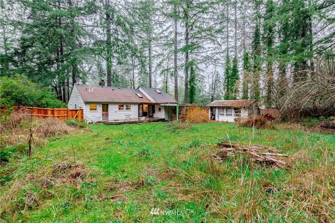 4004 Cooper Point Road Northwest Olympia, WA 98502 - Photo 27 of 28 a view of a house with backyard and sitting area
