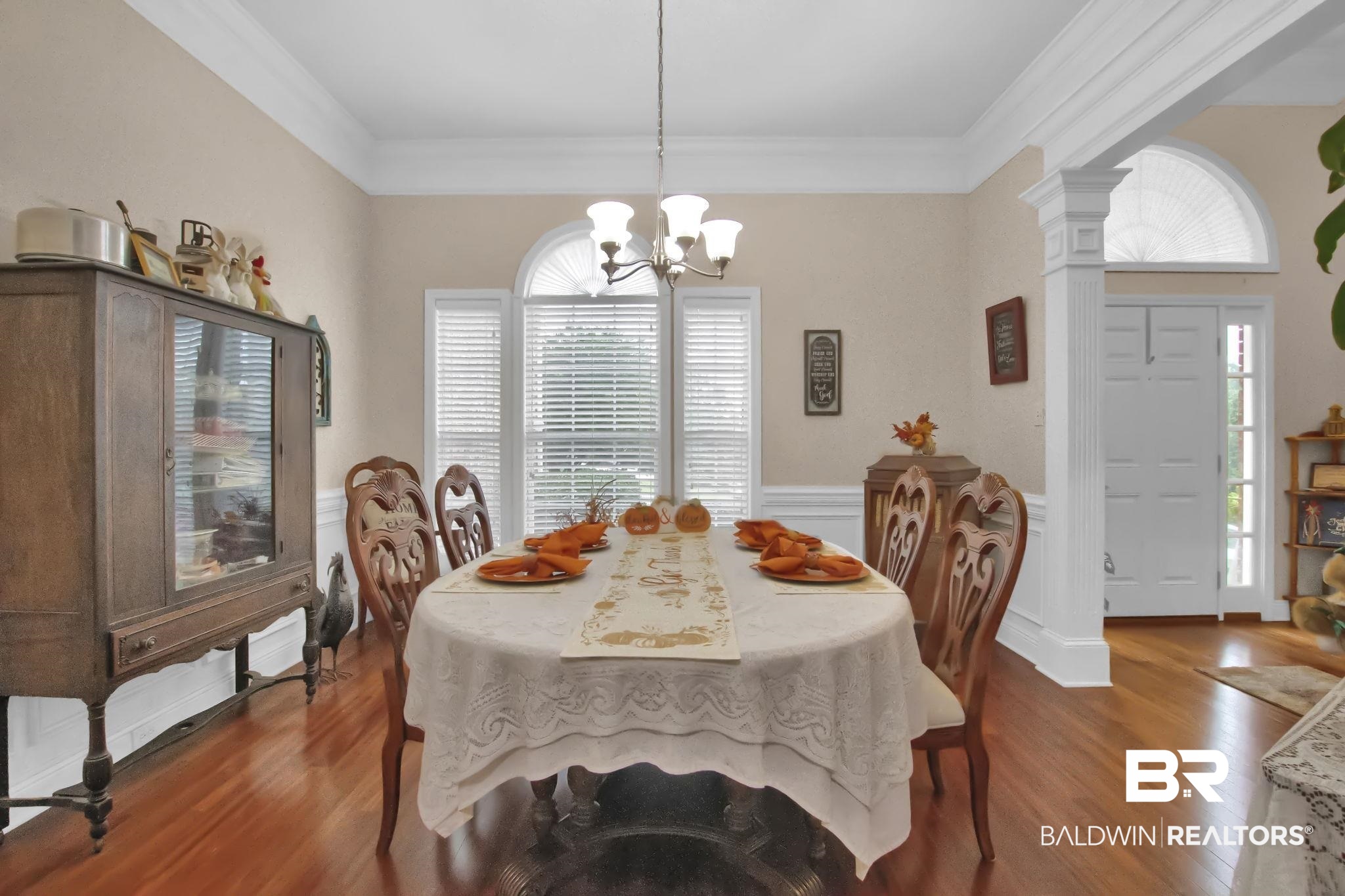 1 Bens Bluff Daphne, AL 36527 - Photo 14 of 56 Dining room featuring ornamental molding, dark wood-type flooring, a healthy amount of sunlight, and a notable chandelier