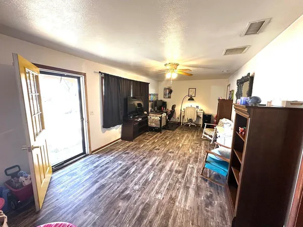 a living room with furniture and a wooden floor