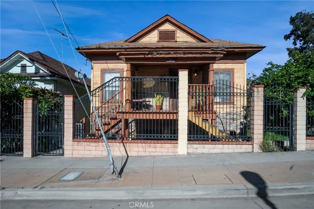 a view of a house with wooden fence