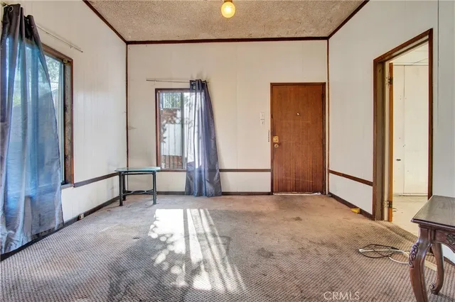 a view of a livingroom with furniture and a window