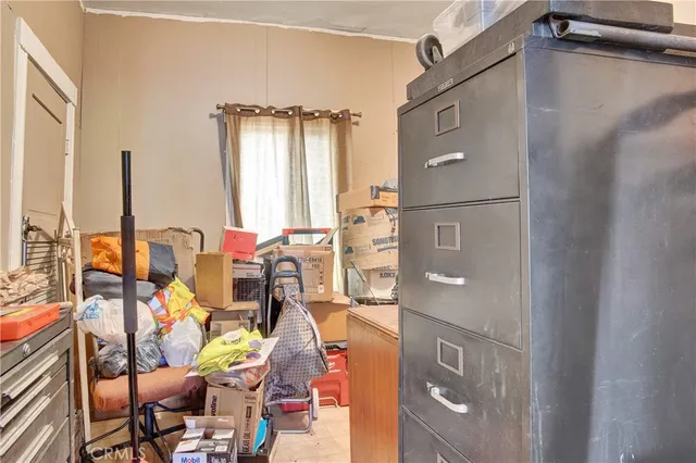 a view of a house with a yard and potted plants