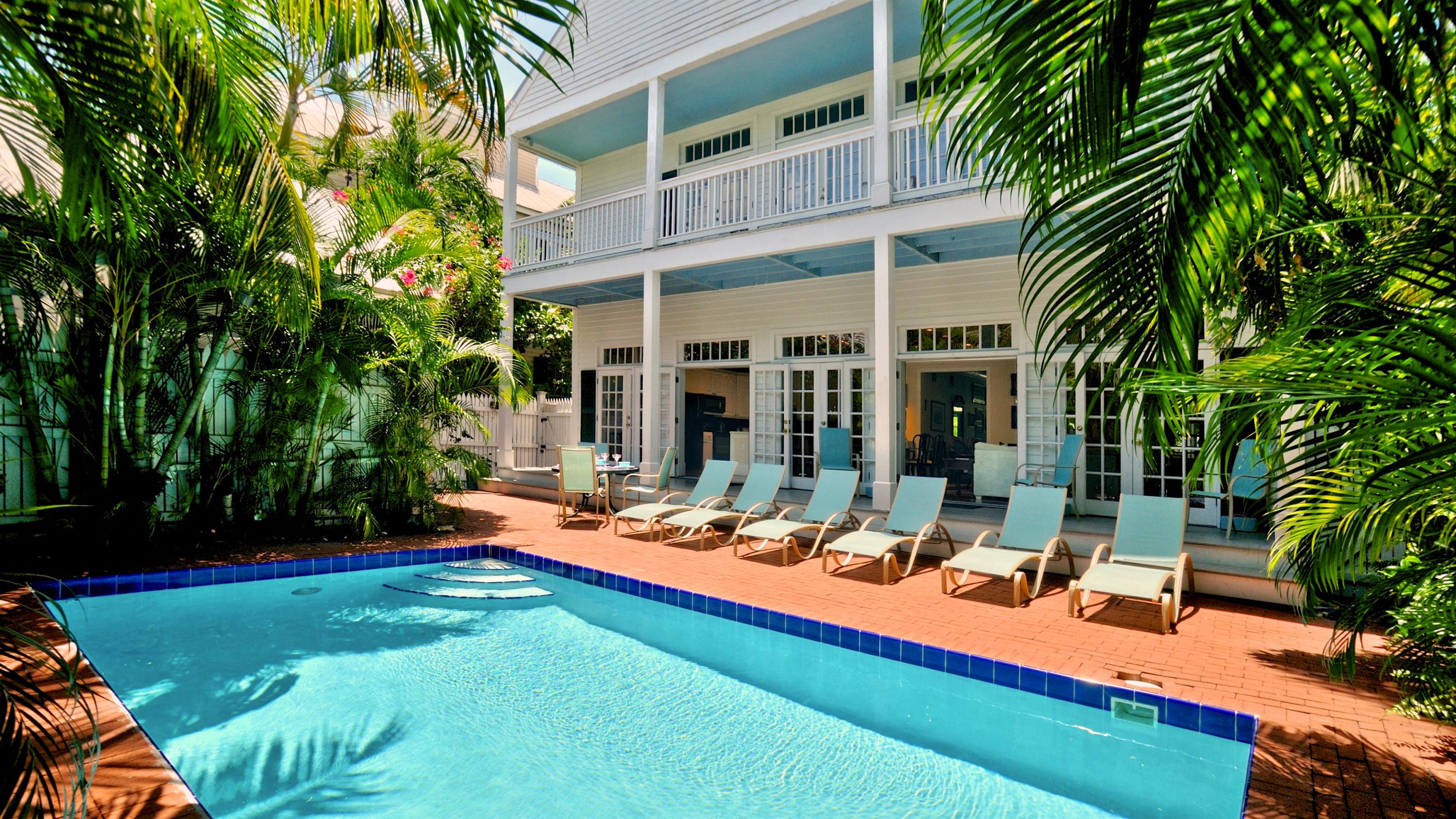 58 Front Street Key West, FL 33040 - Photo 1 of 28 a view of a backyard with plants and patio