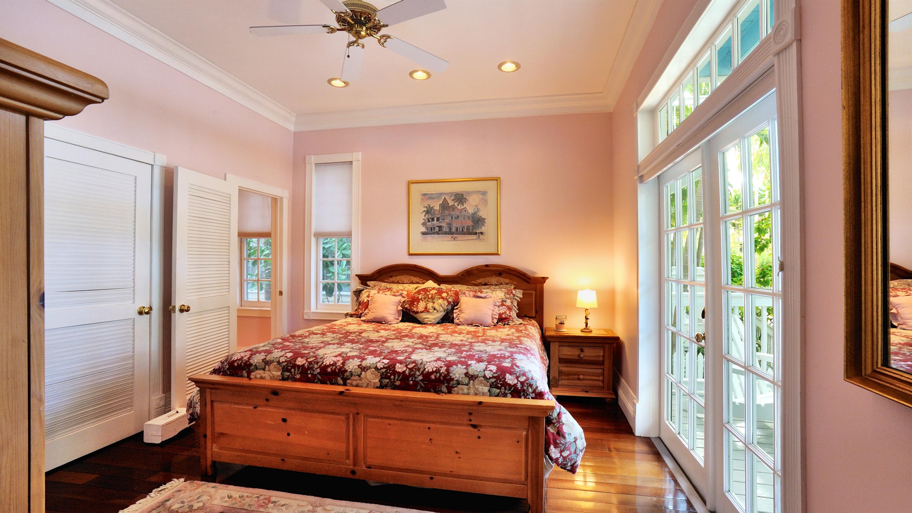 58 Front Street Key West, FL 33040 - Photo 11 of 28 a bedroom with a large bed and a chandelier