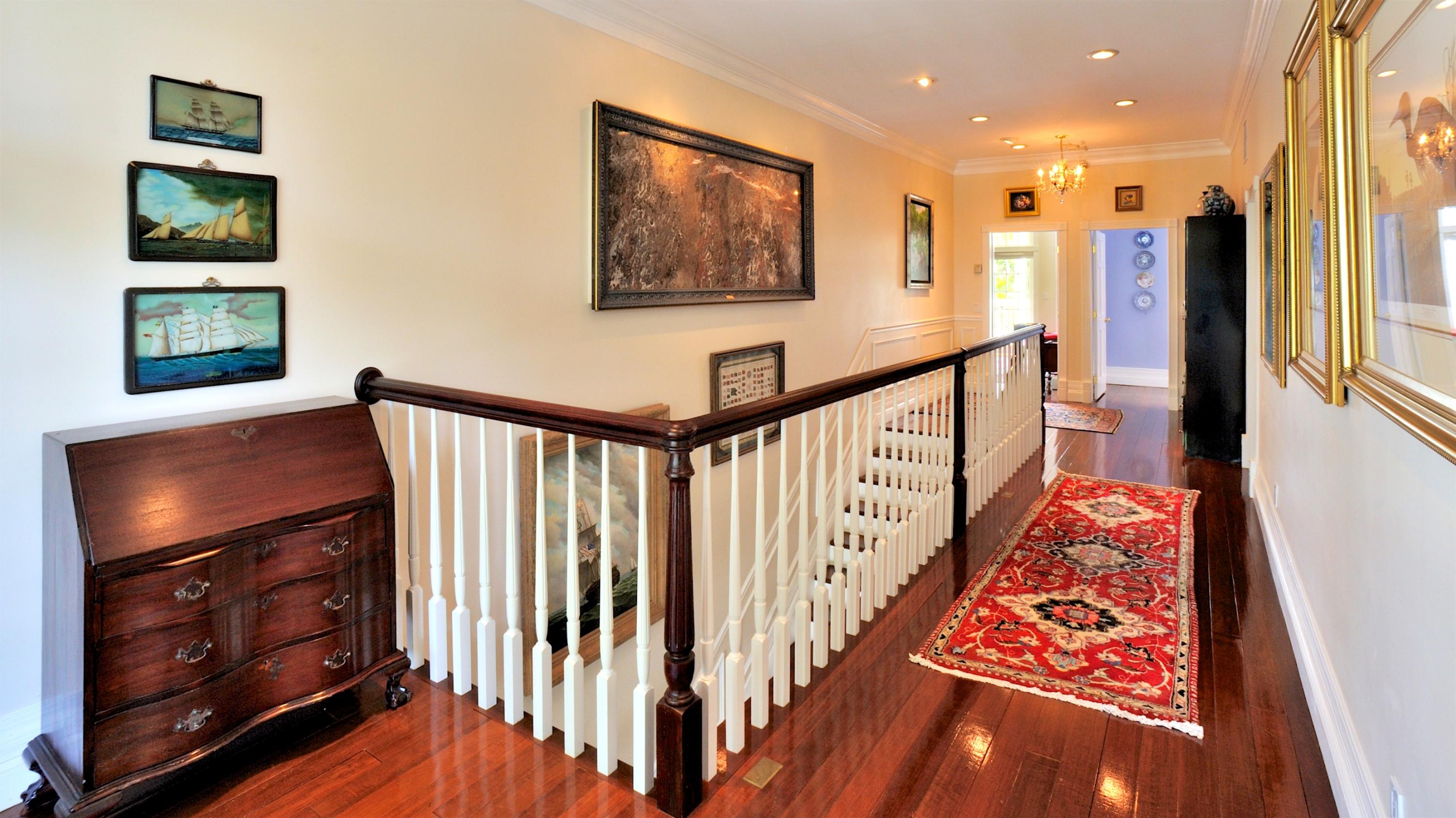 58 Front Street Key West, FL 33040 - Photo 13 of 28 a view of hallway with stairs and wooden floor