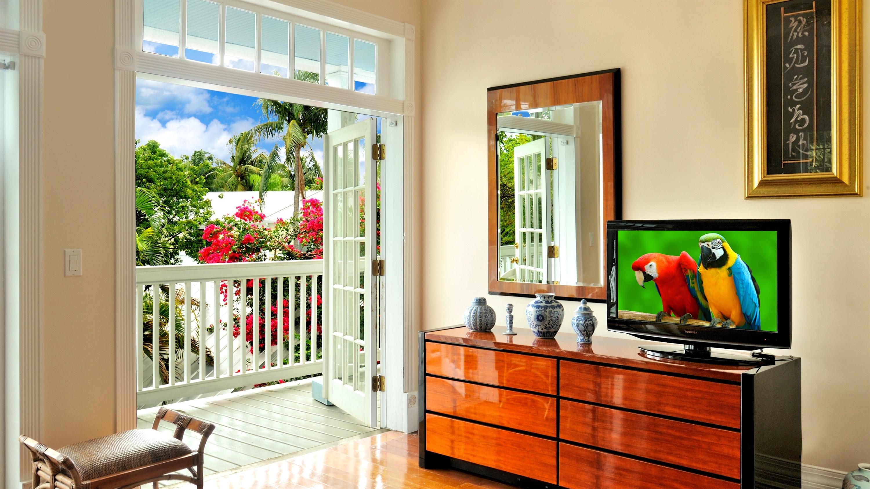 58 Front Street Key West, FL 33040 - Photo 16 of 28 a living room filled with furniture and a flat screen tv