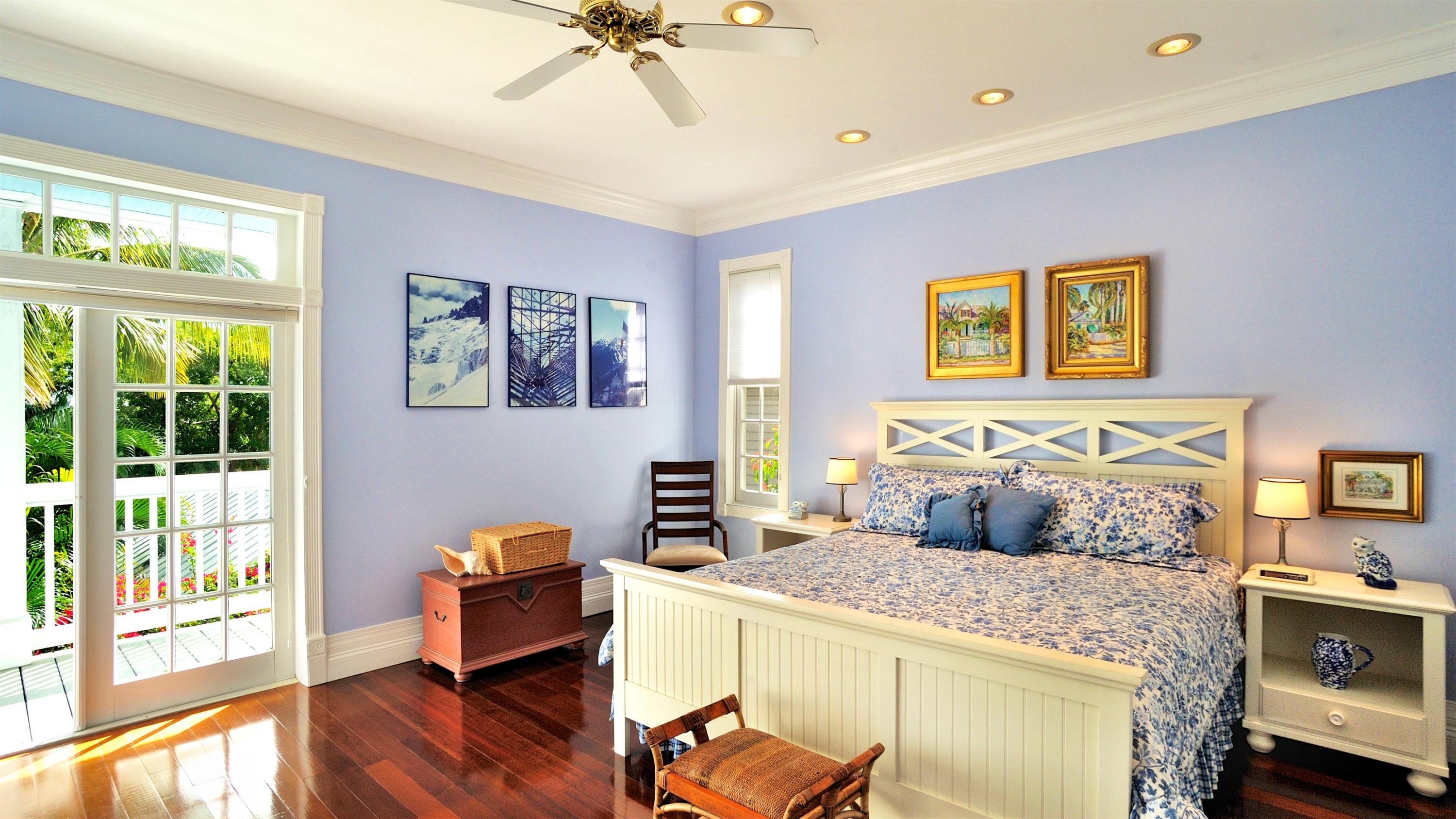 58 Front Street Key West, FL 33040 - Photo 18 of 28 a bedroom with a bed and wooden floor