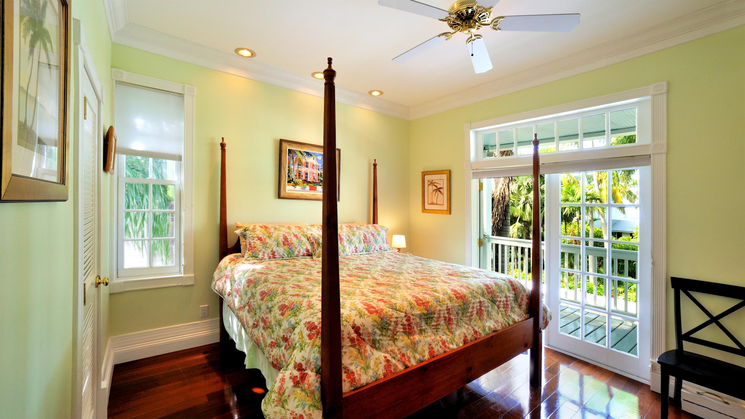 58 Front Street Key West, FL 33040 - Photo 22 of 28 a bed sitting in a bedroom next to a window