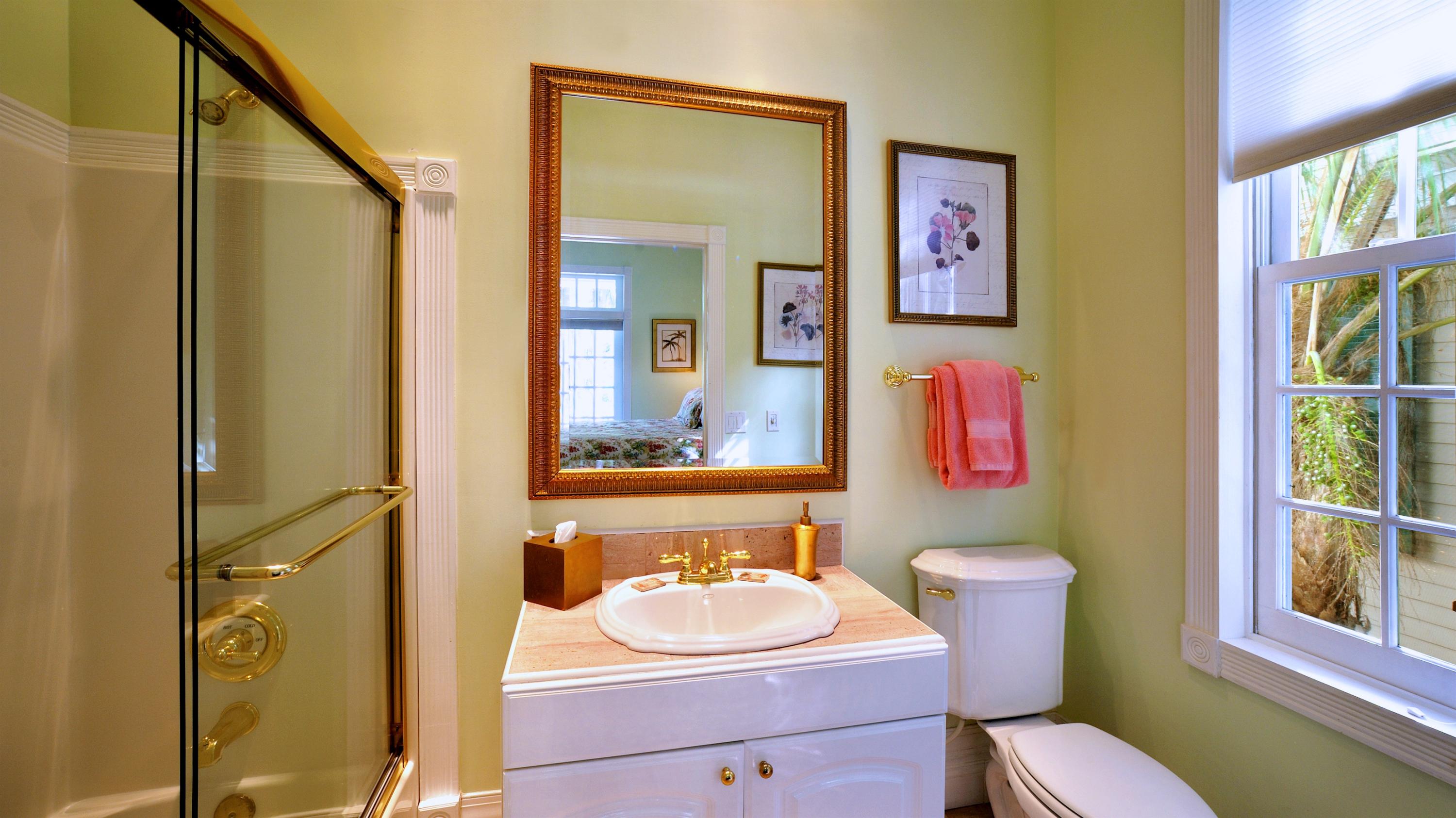 58 Front Street Key West, FL 33040 - Photo 23 of 28 a bathroom with a sink mirror vanity and toilet